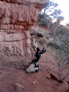 Me trying hard to pull the ropes through to the ground after the rappel - quite the arm workout!