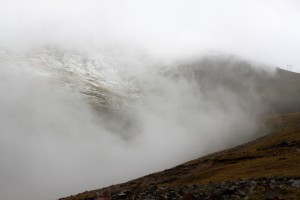 Thick clouds and snowy slopes