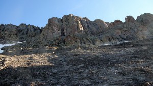The steep, loose, scree-covered slabs up to the lower cliff band on Dallas' south face