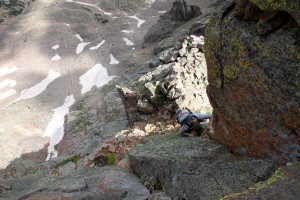 J climbing the low 5th class hand-jam crux up to the summit of Point Odin