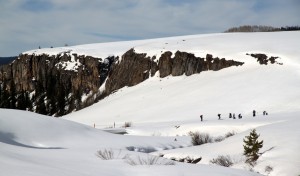Some of our crew switching to uphill skinning mode with Lime Creek Canyon behind